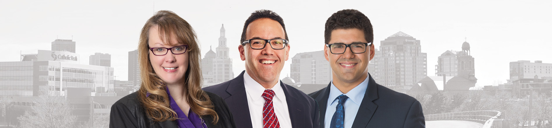 Banner photo of Buffalo NY skyline in background (grayscale) full color photo of Kelly Berg, Albert Nigro and Alexander Carruthers in front of the city skyline.