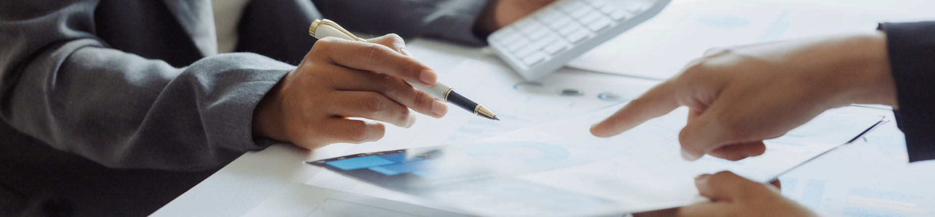 close-up of the hands of business professionals collaborating on a project involving financial documents